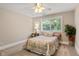 Neutral bedroom with a ceiling fan, window, and carpet at 2010 Stonehedge Rd, Roswell, GA 30075