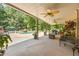 Covered patio leading to a pool and seating area, perfect for outdoor living and entertaining at 2010 Stonehedge Rd, Roswell, GA 30075