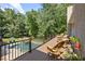 Spacious wooden deck with black railing and lush foliage, perfect for outdoor entertaining overlooking the pool at 2010 Stonehedge Rd, Roswell, GA 30075