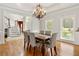 Bright dining room with hardwood floors, wainscoting, chandelier, and natural light from large windows at 2010 Stonehedge Rd, Roswell, GA 30075