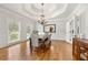 Elegant dining room with coffered ceiling, hardwood floors, chandelier, and ample natural light at 2010 Stonehedge Rd, Roswell, GA 30075
