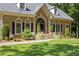 Beautiful home with arched windows and manicured landscaping at 2010 Stonehedge Rd, Roswell, GA 30075