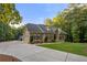 Spacious home with a long driveway and lush landscaping at 2010 Stonehedge Rd, Roswell, GA 30075