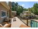 Expansive deck with outdoor seating, an in-ground pool, and verdant landscaping at 2010 Stonehedge Rd, Roswell, GA 30075