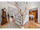 Elegant foyer with hardwood floors, staircase, and a view of the living room and formal piano room at 2010 Stonehedge Rd, Roswell, GA 30075