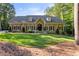 Charming home featuring a manicured lawn and mature trees at 2010 Stonehedge Rd, Roswell, GA 30075