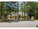 Well-maintained home with a circular driveway and mature trees at 2010 Stonehedge Rd, Roswell, GA 30075