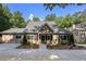Charming home with a welcoming front porch, meticulously landscaped yard, and a long driveway at 2010 Stonehedge Rd, Roswell, GA 30075