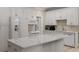Modern white kitchen with an island, stainless appliances, and plenty of cabinet space at 2010 Stonehedge Rd, Roswell, GA 30075
