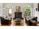 Elegant living room featuring a fireplace, hardwood floors, and french doors to the outside at 2010 Stonehedge Rd, Roswell, GA 30075