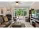 Cozy living room with a fireplace and doors leading to an outdoor space at 2010 Stonehedge Rd, Roswell, GA 30075