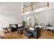 Open-concept living room with vaulted ceiling, hardwood floors, staircase and plenty of room to entertain at 2010 Stonehedge Rd, Roswell, GA 30075