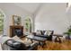 Bright living room boasts hardwood floors, fireplace, and french doors offering natural light and outdoor views at 2010 Stonehedge Rd, Roswell, GA 30075