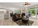 Cozy living space open to the kitchen with a fireplace, large windows, and hardwood flooring at 2010 Stonehedge Rd, Roswell, GA 30075