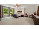 Spacious main bedroom with a large window view, ceiling fan, and neutral carpet at 2010 Stonehedge Rd, Roswell, GA 30075