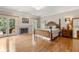 Spacious primary bedroom suite with hardwood floors, fireplace, and french doors to private balcony at 2010 Stonehedge Rd, Roswell, GA 30075