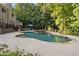 Gorgeous backyard with a kidney-shaped pool, stone-accented hot tub, and spacious deck for sunbathing and outdoor activities at 2010 Stonehedge Rd, Roswell, GA 30075
