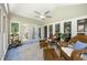 Charming sunroom with tile flooring, ceiling fan, and floor-to-ceiling windows to enjoy the scenery at 2010 Stonehedge Rd, Roswell, GA 30075