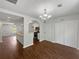 Bright dining room with hardwood floors and a modern chandelier with neutral paint throughout at 3384 Brookside Ln, Jonesboro, GA 30236