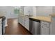 Kitchen featuring stainless steel appliances, white cabinetry, laminate countertops and hardwood floors at 3384 Brookside Ln, Jonesboro, GA 30236