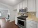 Kitchen features white cabinets, stainless steel appliances and laminate countertops at 3384 Brookside Ln, Jonesboro, GA 30236