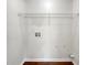 Empty laundry room area with white walls and wood flooring; washer and dryer hookups available at 3384 Brookside Ln, Jonesboro, GA 30236