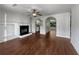 Living room featuring a fireplace and a ceiling fan, with hardwood floors throughout the house at 3384 Brookside Ln, Jonesboro, GA 30236