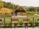 Lou Sobh amphitheater with stone pillars, black awning, green grass, and stadium seating at 630 Skytop Dr # 157, Cumming, GA 30040