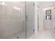 Modern bathroom featuring glass shower with grey tile and chrome fixtures, hallway visible in background at 630 Skytop Dr # 157, Cumming, GA 30040