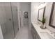 Bathroom featuring double sink vanity and glass shower at 630 Skytop Dr # 157, Cumming, GA 30040