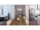 Dining area with a wooden table, upholstered chairs, and a view into the kitchen and living room at 630 Skytop Dr # 157, Cumming, GA 30040