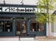 A storefront with seating and large windows, showcasing a modern aesthetic at 630 Skytop Dr # 157, Cumming, GA 30040