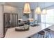 Bright kitchen featuring stainless steel appliances, a large island with pendant lighting, and white cabinets at 630 Skytop Dr # 157, Cumming, GA 30040