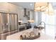 A bright, open kitchen with stainless steel appliances, a center island, and stylish pendant lights at 630 Skytop Dr # 157, Cumming, GA 30040