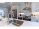 Modern kitchen showcasing stainless steel appliances, white cabinets, and a sleek countertop with a stainless sink at 630 Skytop Dr # 157, Cumming, GA 30040