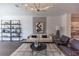 Bright living room features modern decor, neutral paint, stylish shelving, and elegant light fixture at 630 Skytop Dr # 157, Cumming, GA 30040