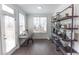 Bright home office with large windows, modern desk, hardwood floors, and decorative shelving at 630 Skytop Dr # 157, Cumming, GA 30040