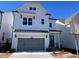 Charming two-story white home with a gray two car garage and black trim at 633 Skytop Dr, Cumming, GA 30040