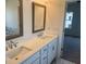 Bright bathroom boasts double vanity and a glimpse into the bedroom at 621 Silva St # 124, Cumming, GA 30040