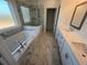 Elegant bathroom with marble tile, double vanity, soaking tub, and walk-in shower at 621 Silva St # 124, Cumming, GA 30040