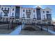 Charming three-story townhome with landscaped front yard and dark metal fence at 621 Silva St # 124, Cumming, GA 30040