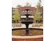 Ornate three-tiered fountain in a brick plaza, creating a focal point at 621 Silva St # 124, Cumming, GA 30040