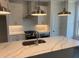 Bright kitchen with a large island, stainless steel appliances, and modern lighting at 621 Silva St # 124, Cumming, GA 30040