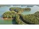 Aerial view featuring waterfront homes surrounded by lush forest and serene lake waters at 635 Skytop Dr, Cumming, GA 30040