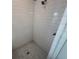 Modern bathroom featuring subway tiles, a rain shower head, and elegant hexagon tile flooring at 635 Skytop Dr, Cumming, GA 30040