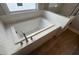 Close-up of bathtub with tile surround and modern fixtures at 635 Skytop Dr, Cumming, GA 30040