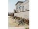 Outdoor bike rack in a community space; white brick building with mural in the background at 635 Skytop Dr, Cumming, GA 30040