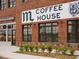 Coffee House retail exterior enhanced by brick facade, large windows, and professionally landscaped frontage at 635 Skytop Dr, Cumming, GA 30040