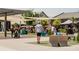 People gathering in a vibrant community space with shade structures and colorful seating at 635 Skytop Dr, Cumming, GA 30040