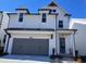 Charming two-story home featuring a two-car garage, a covered entryway and a light-colored facade at 635 Skytop Dr, Cumming, GA 30040